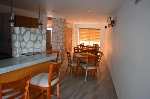 a kitchen and dining room with a table and chairs at Hotel la Cuesta Toscana in Bernal