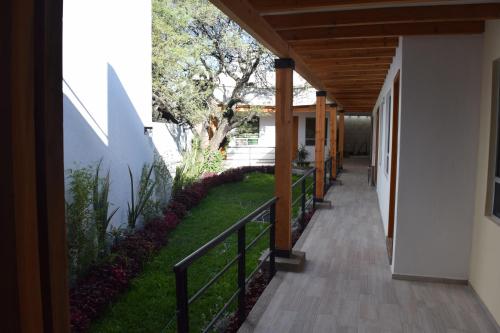 a walkway in a house with a fence at Hotel la Cuesta Toscana in Bernal