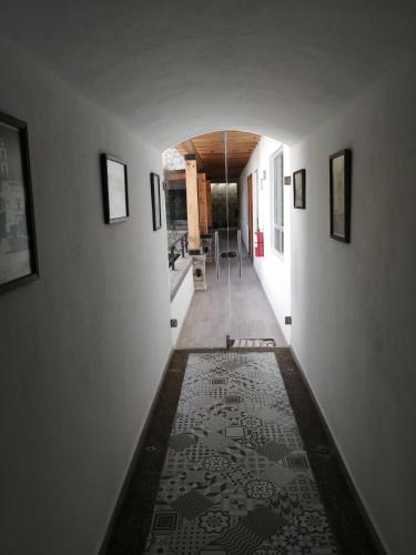 a hallway with a rug on the floor of a house at Hotel la Cuesta Toscana in Bernal