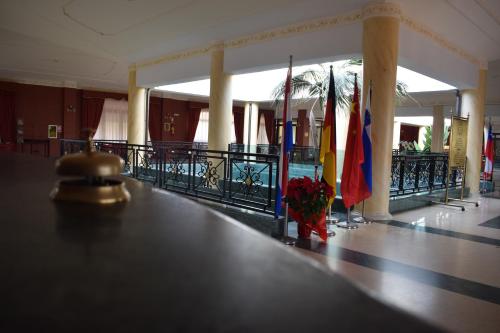 a hallway with flags and a table in a building at Hotel Villa Peretti in Gela