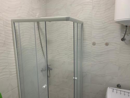 a shower with a glass door in a bathroom at Apartments Old Town Izola in Izola