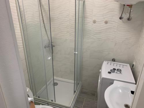 a bathroom with a shower and a toilet and a sink at Apartments Old Town Izola in Izola