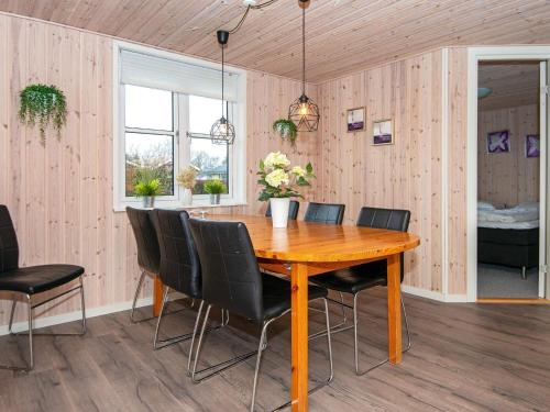 a dining room with a wooden table and chairs at 8 person holiday home in Haderslev in Haderslev