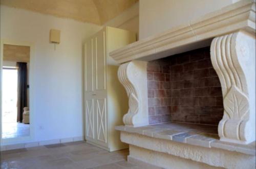 a living room with a brick fireplace in a house at Agriturismo Masseria San Leonardo in Savelletri di Fasano
