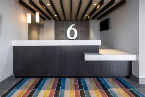 a lobby with a counter with the number six on it at Motel 6-Fontana, CA in Fontana