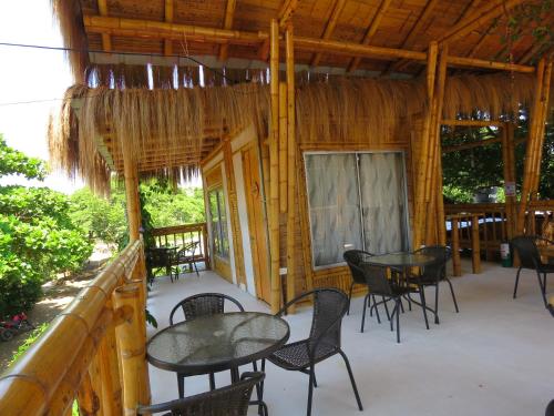 a patio with tables and chairs in a cabin at Tatacoa Star Eco Hotel in Villavieja