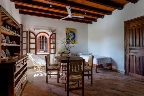 
a living room filled with furniture and a wooden table at Suites La Hacienda in Puerto Escondido
