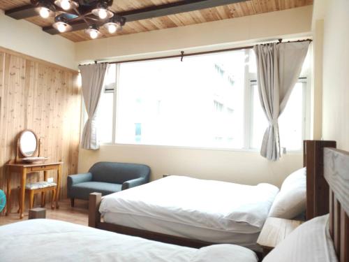 Ένα ή περισσότερα κρεβάτια σε δωμάτιο στο 吉住民宿