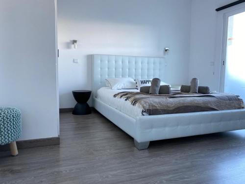 a bedroom with a large white bed in a room at Deluxe apartment in Albufeira old town, 200m walk to beach, pool parking in Albufeira