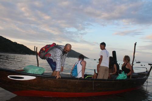 a group of people in a boat on the water at Cham Island Smiles Homestay in Tân Hiệp