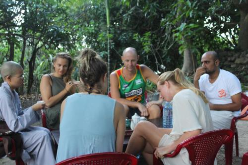 a group of people sitting around a table at Cham Island Smiles Homestay in Tân Hiệp