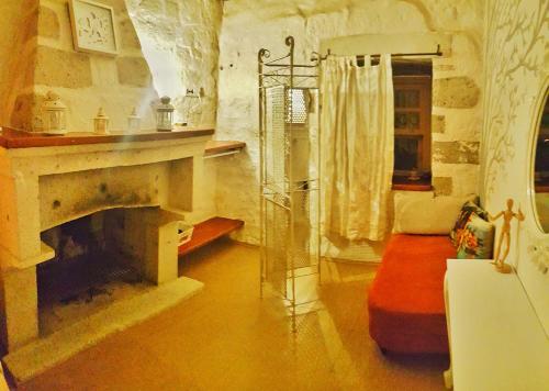 a living room with a fireplace and a shower at Lilyum Alaçatı - Taş Ev in Alacati