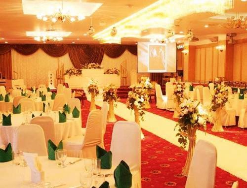 a banquet hall with white tables and white chairs at Hotel The Palace Daegu in Daegu