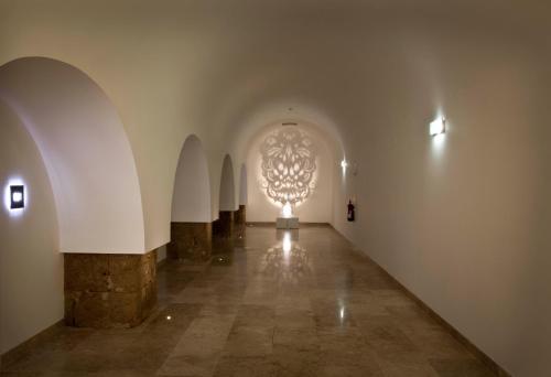 a hallway with a large chandelier in a building at Pestana Cidadela Cascais - Pousada & Art District in Cascais