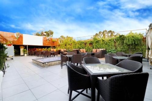 a patio with tables and chairs on a patio at Hotel City Heart Premium in Chandīgarh