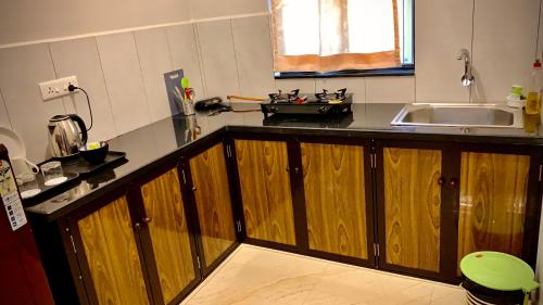 a kitchen with a wooden counter top and a sink at Stan-Inn, North Goa, Vagator, with strong WIFI,free private parking & kitchen, Can Cook where you stay in Vagator