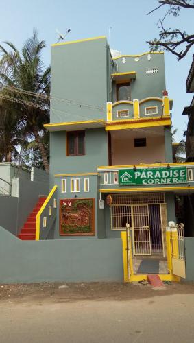 a building with a sign on the side of it at Paradise corner in Pondicherry