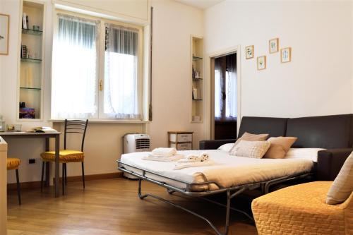 a room with a bed and a table in it at Martesana Studio Flat close to Yellow Metro in Milan