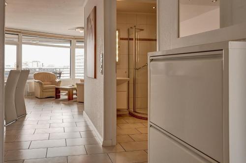 a kitchen with a refrigerator and a living room at Grömitz Center I Wohnung 874 in Grömitz