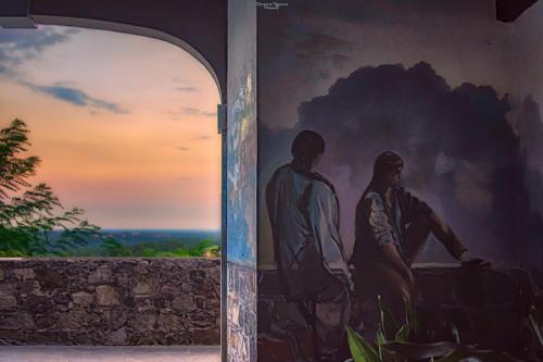 a mural of two men on the side of a wall at Affittacamere CASA DOLCE CASA SAN DANIELE in San Daniele del Friuli