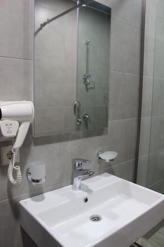 a bathroom with a sink and a shower at Hotel City Lights - Tbilisi in Tbilisi City