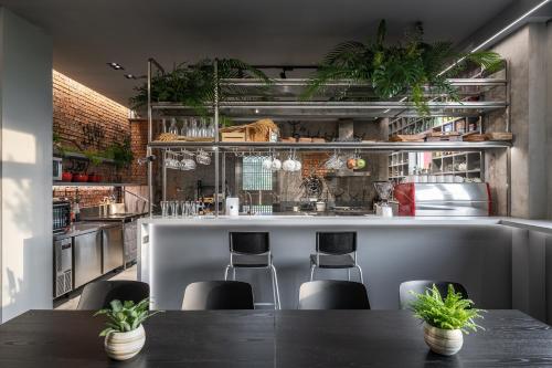 a kitchen with a counter with chairs and plants at Farmland B&B in Guilin