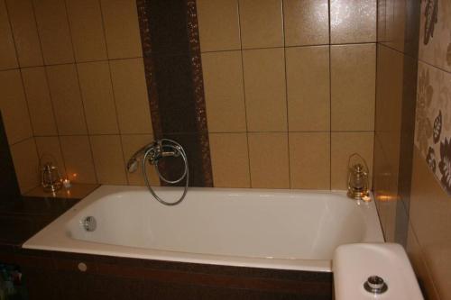 a white bath tub in a bathroom with a toilet at KIKI Stegna in Archangelos