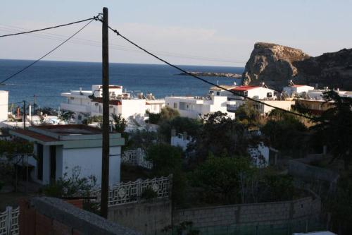 a view of a town with white buildings and the ocean at KIKI Stegna in Archangelos