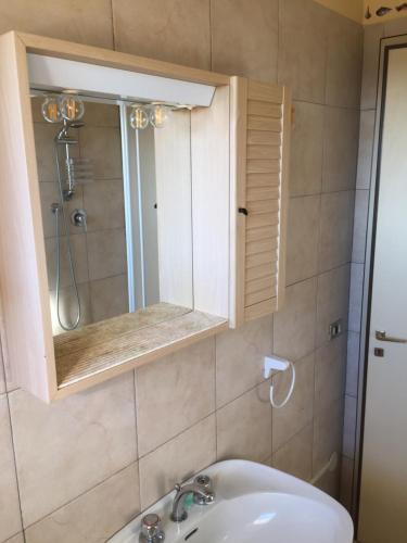 a bathroom with a sink and a mirror at Emozione Marina - appartamento fronte mare in Marcelli