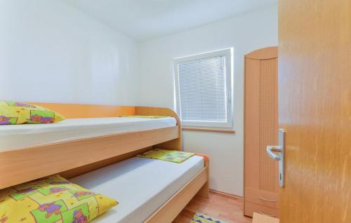 Postel nebo postele na pokoji v ubytování Apartmani Vugec, Povljana - Pag