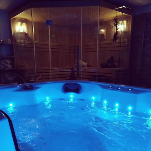 a hot tub with blue lights in a room at Kuća za odmor Bitoševje in Klenovnik