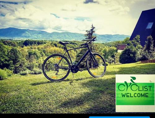 a bike parked on the grass in a field at Kuća za odmor Bitoševje in Klenovnik