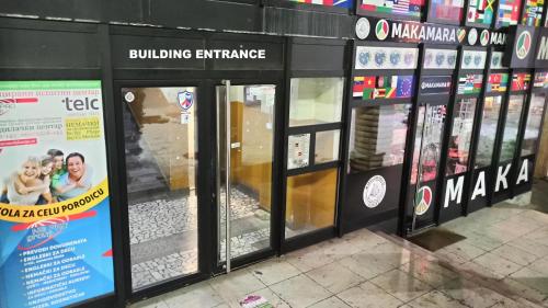 a row of glass doors in a store at Studio Trg in Užice