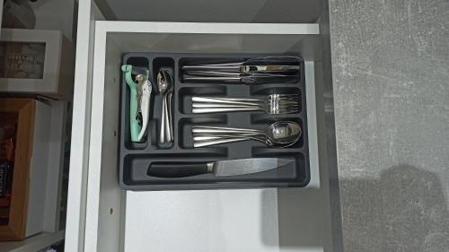 a drawer filled with utensils in a refrigerator at Studio Trg in Užice