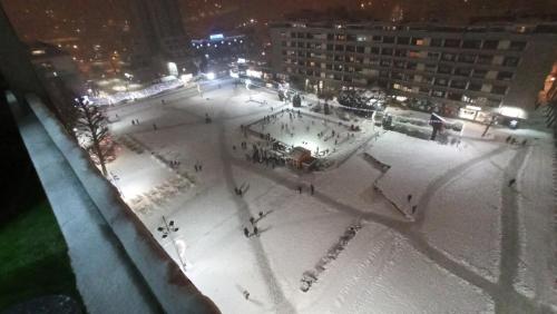 an aerial view of a skating rink at night at Studio Trg in Užice