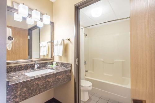 a bathroom with a sink and a toilet at AmericInn by Wyndham West Salem in West Salem