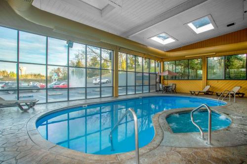 a pool in a hotel room with a view of a parking lot at Baymont by Wyndham Branson - On the Strip in Branson