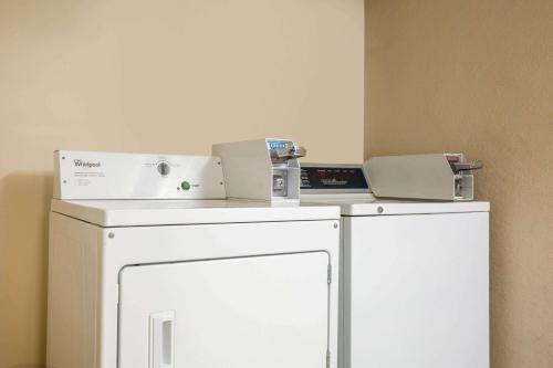 a white refrigerator with a machine on top of it at Baymont by Wyndham Branson - On the Strip in Branson