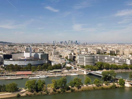 a view of a city with a river and buildings at Novotel Paris Centre Tour Eiffel in Paris