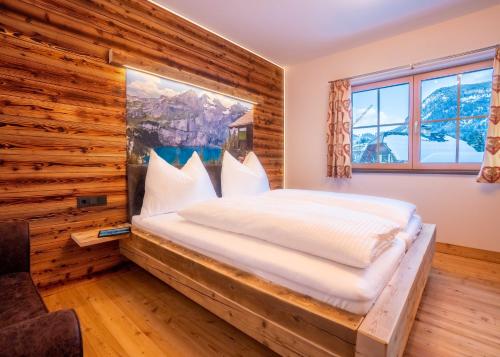 ein Schlafzimmer mit einem Bett in einer Holzwand in der Unterkunft Schitter-Appartements in Mauterndorf