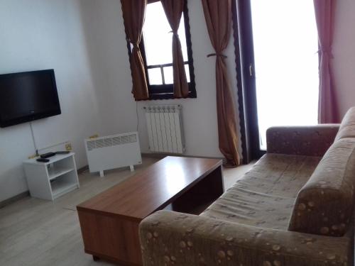 a living room with a couch and a coffee table at Apartment Nice View in Fojnica