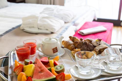 a tray with a tray of food on a table at Bike Hotel Touring Gardone Riviera & Beach in Gardone Riviera