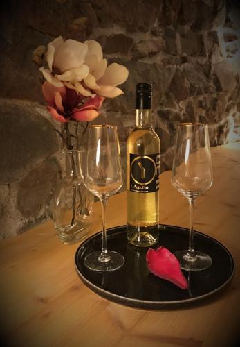 a bottle of wine on a tray with two wine glasses at Le 30 in Troistorrents