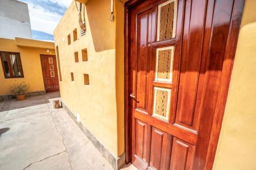 an open wooden door of a building with a courtyard at Cabañas Santa Catalina in Tilcara