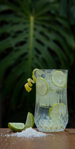 a glass of lemonade with lime slices on a table at Gateway Coonoor in Coonoor