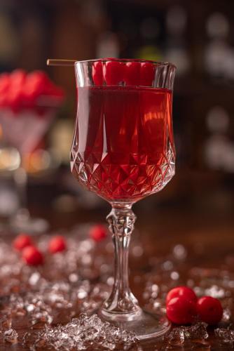 a red drink in a wine glass on a table at Gateway Coonoor in Coonoor