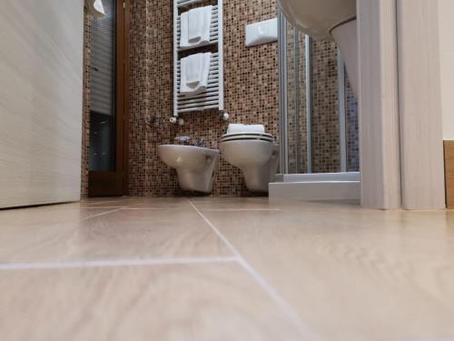 a bathroom with two toilets and a sink at B&B Rossini Luxury 2 in Cosenza