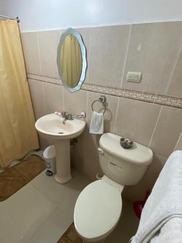 a small bathroom with a toilet and a sink at 1Dom Rep - Huge cozy 3 bedrooms - close to all transportation Jacobo Majluta - Residencial Paradise V Colina Arroyo 1 in Santo Domingo