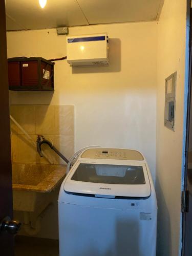 a washing machine in a room with a sink at 1Dom Rep - Huge cozy 3 bedrooms - close to all transportation Jacobo Majluta - Residencial Paradise V Colina Arroyo 1 in Santo Domingo