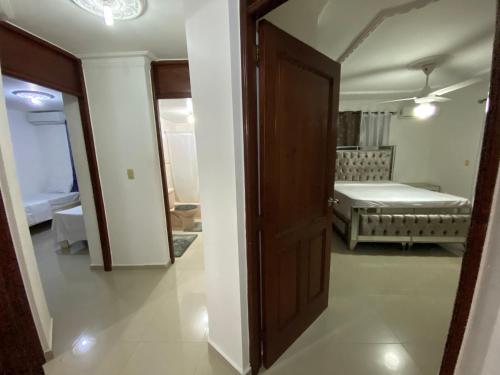 an open door to a room with a bedroom at 1Dom Rep - Huge cozy 3 bedrooms - close to all transportation Jacobo Majluta - Residencial Paradise V Colina Arroyo 1 in Santo Domingo